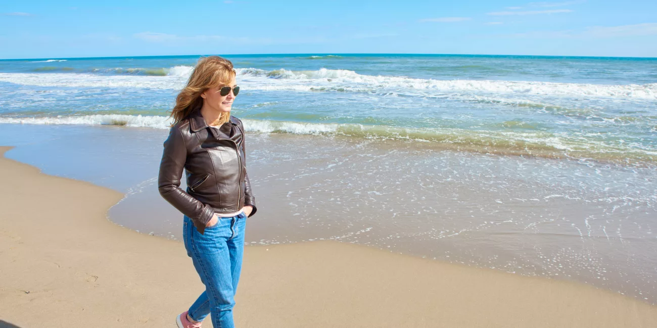 Person in active wear walking outside in natural light, post weight loss