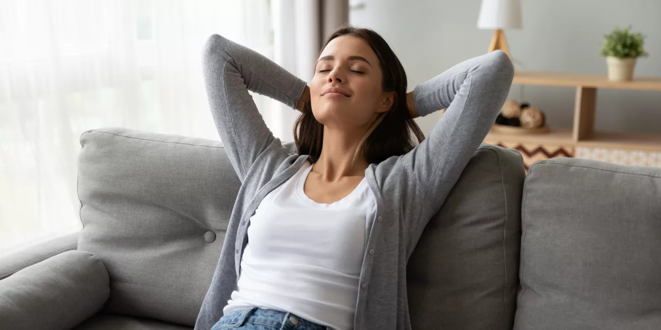 Woman resting comfortably at home in natural light during recovery