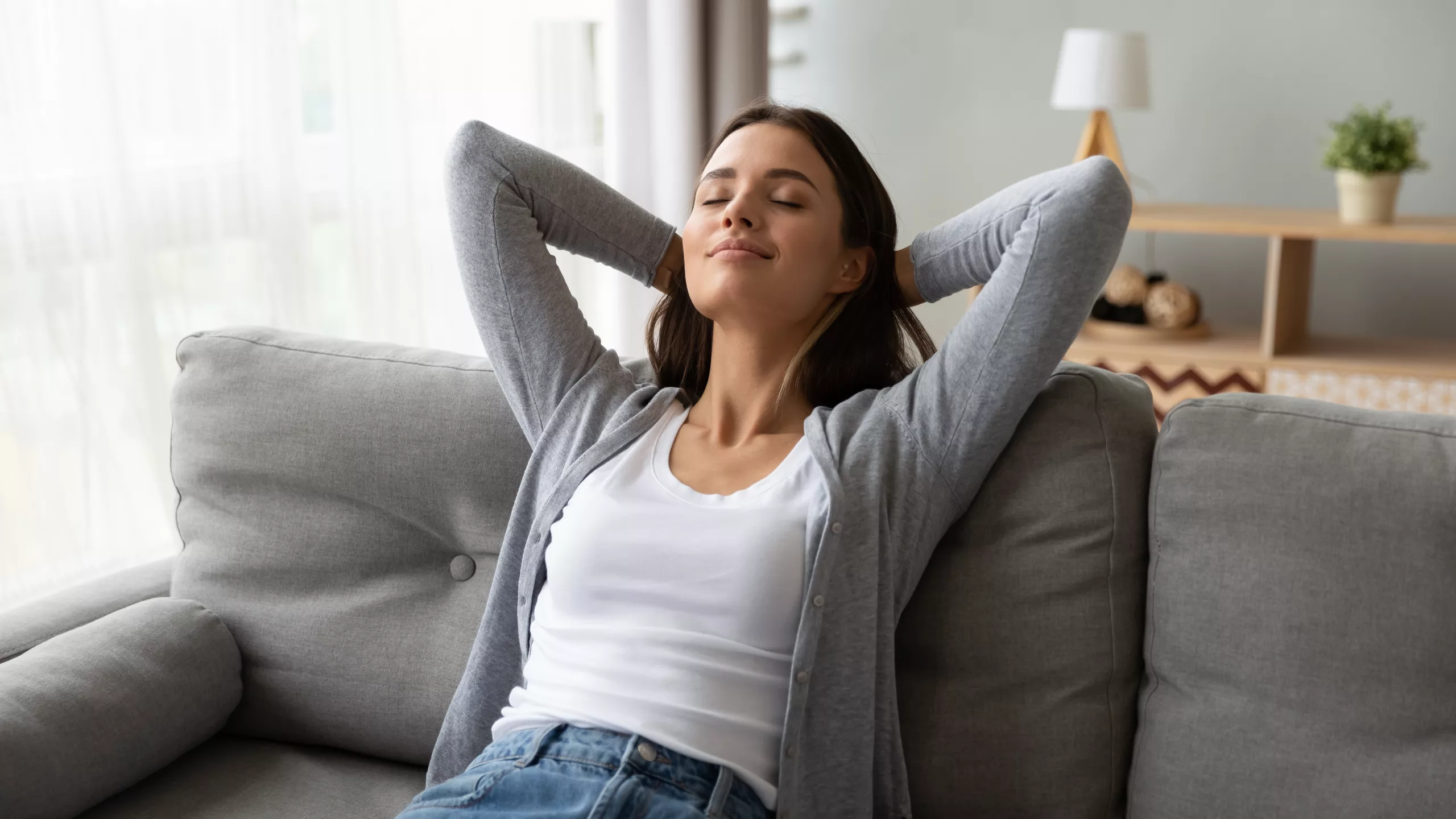 Woman resting comfortably at home in natural light during recovery