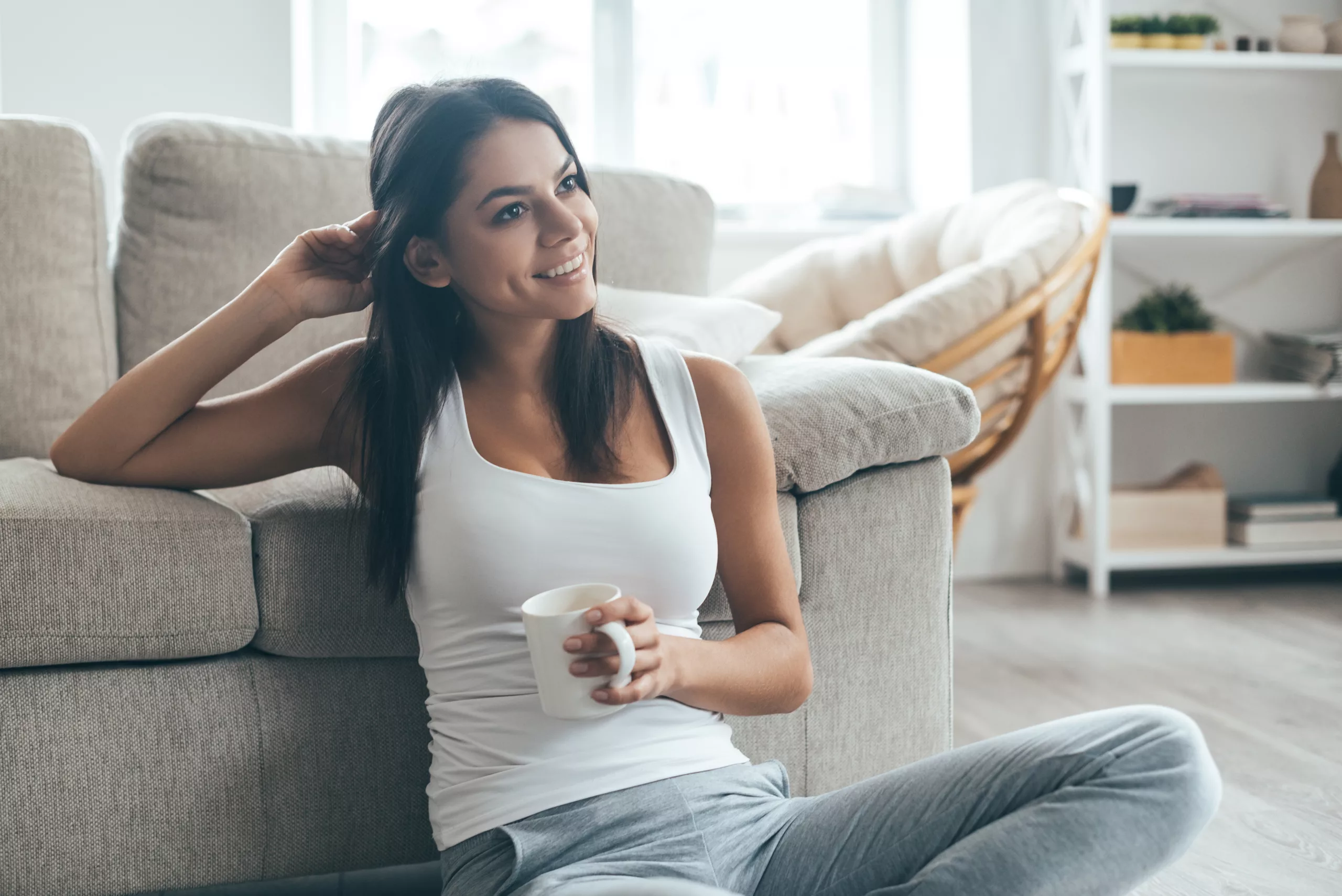 Woman in active wear in natural light, considering body contouring options