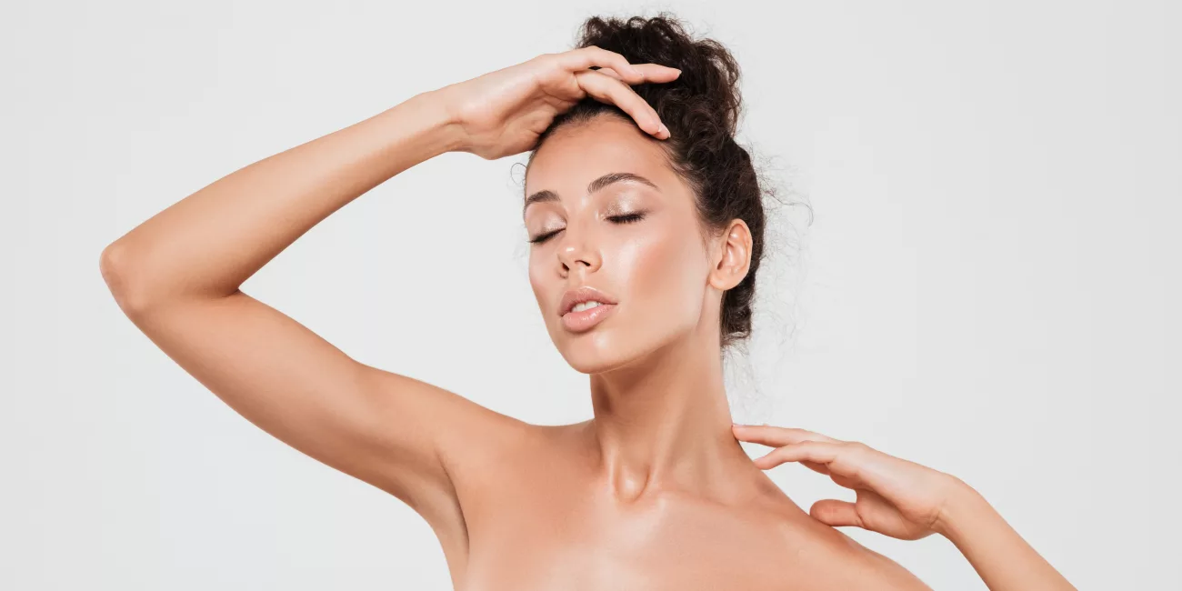 Woman in soft cotton clothing in natural light, considering breast surgery options